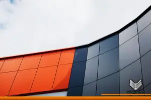 Paneles de aluminio naranja y negro instalados como fachada de un edificio